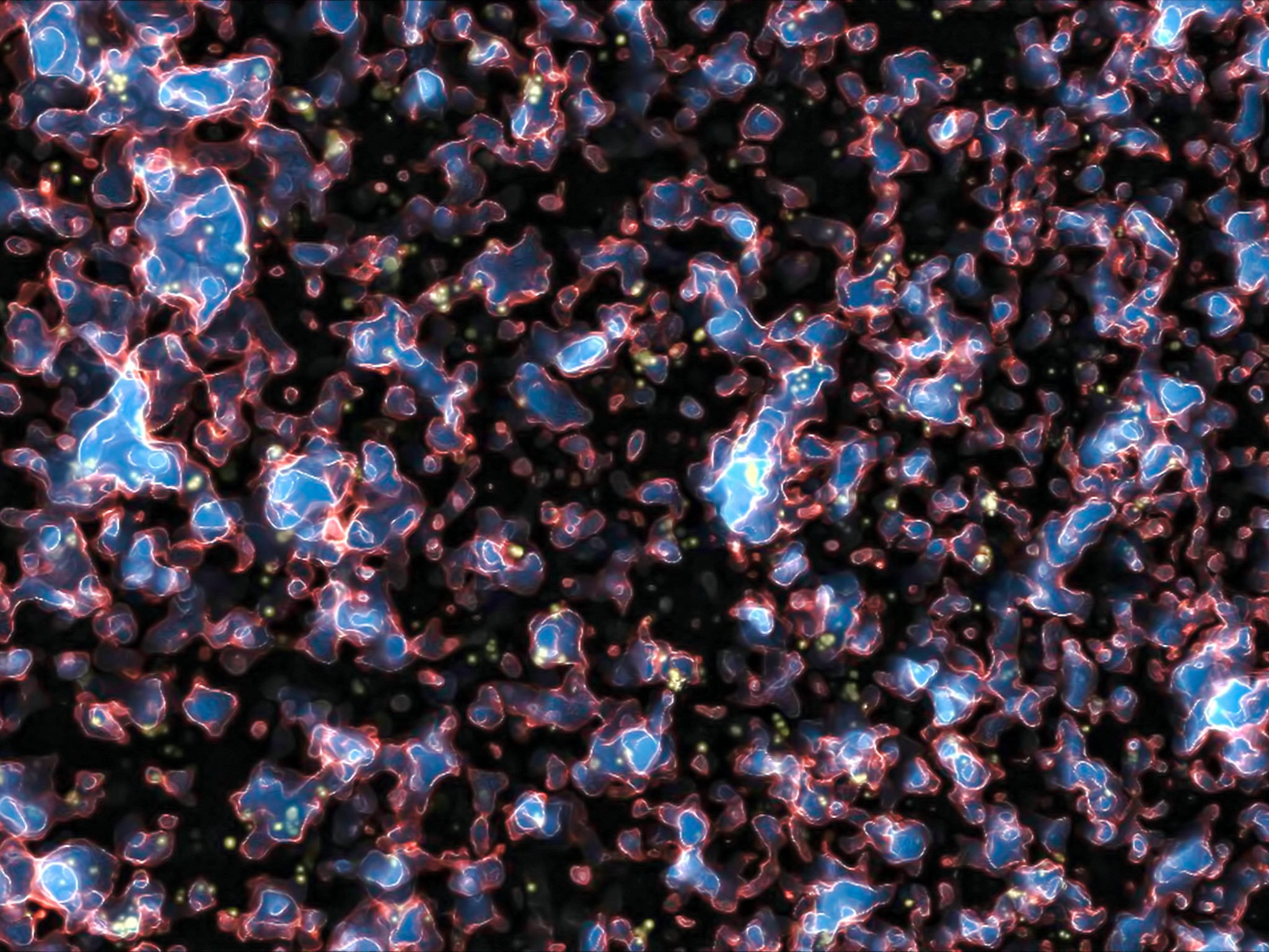Une image extraite d'une simulation montrant la réionisation de l'Univers observable sous l'influence du rayonnement ultraviolet des galaxies, quelques centaines de millions d'années après la recombinaison et l'émission du rayonnement fossile. Les zones ionisées par le rayonnement UV, et qui sont devenues translucides, sont en bleu. Les régions opaques aux UV, contenant encore de l'hydrogène et de l'hélium neutres, sont en noir. Le front d'ionisation est quant à lui représenté en rouge et blanc. Une vidéo complète de cette simulation se trouve sur le site de son auteur, Marcelo Alvarez. © M. Alvarez, R. Kaehler et T. Abel